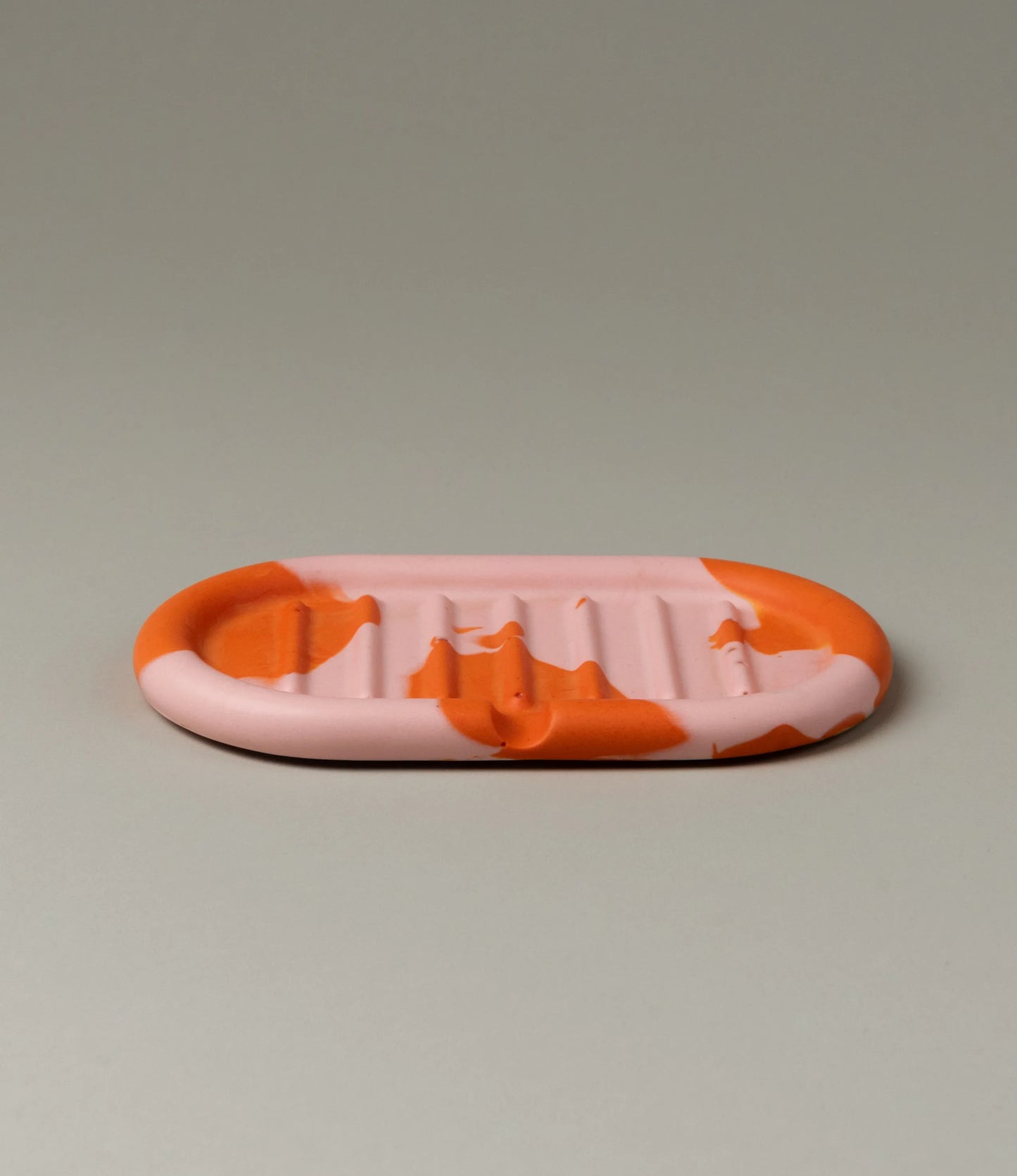 Soap Holder from Gritful Homeware in the maximalist color pairing of light rose and orange. The soap dish has a rounded shape which matches the pattern of the item, which is very much organic. 