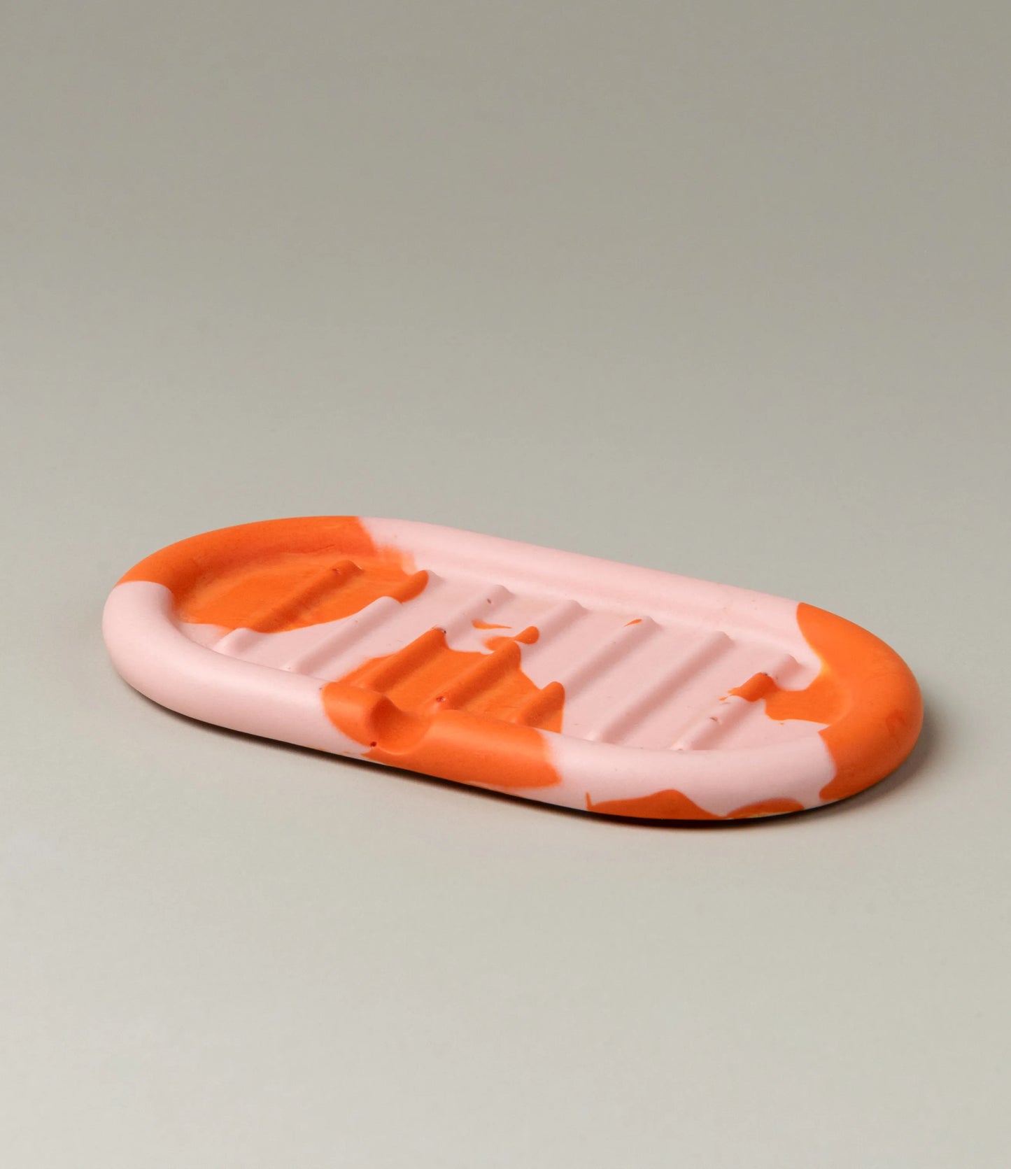 Soap Holder from Gritful Homeware in the maximalist color pairing of light rose and orange. The soap dish has a rounded shape which matches the pattern of the item, which is very much organic. 