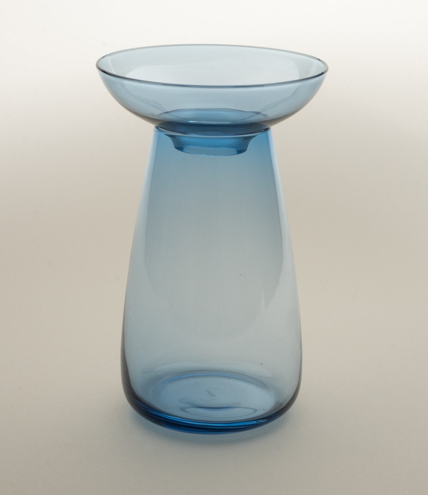 Aqua Culture Vase from Kinto is a vase to grow new plants. The vase consists of two pieces, a base and a dish for the top, which holds the bulbs, seeds or leaves. This variant is made from a blue glass.