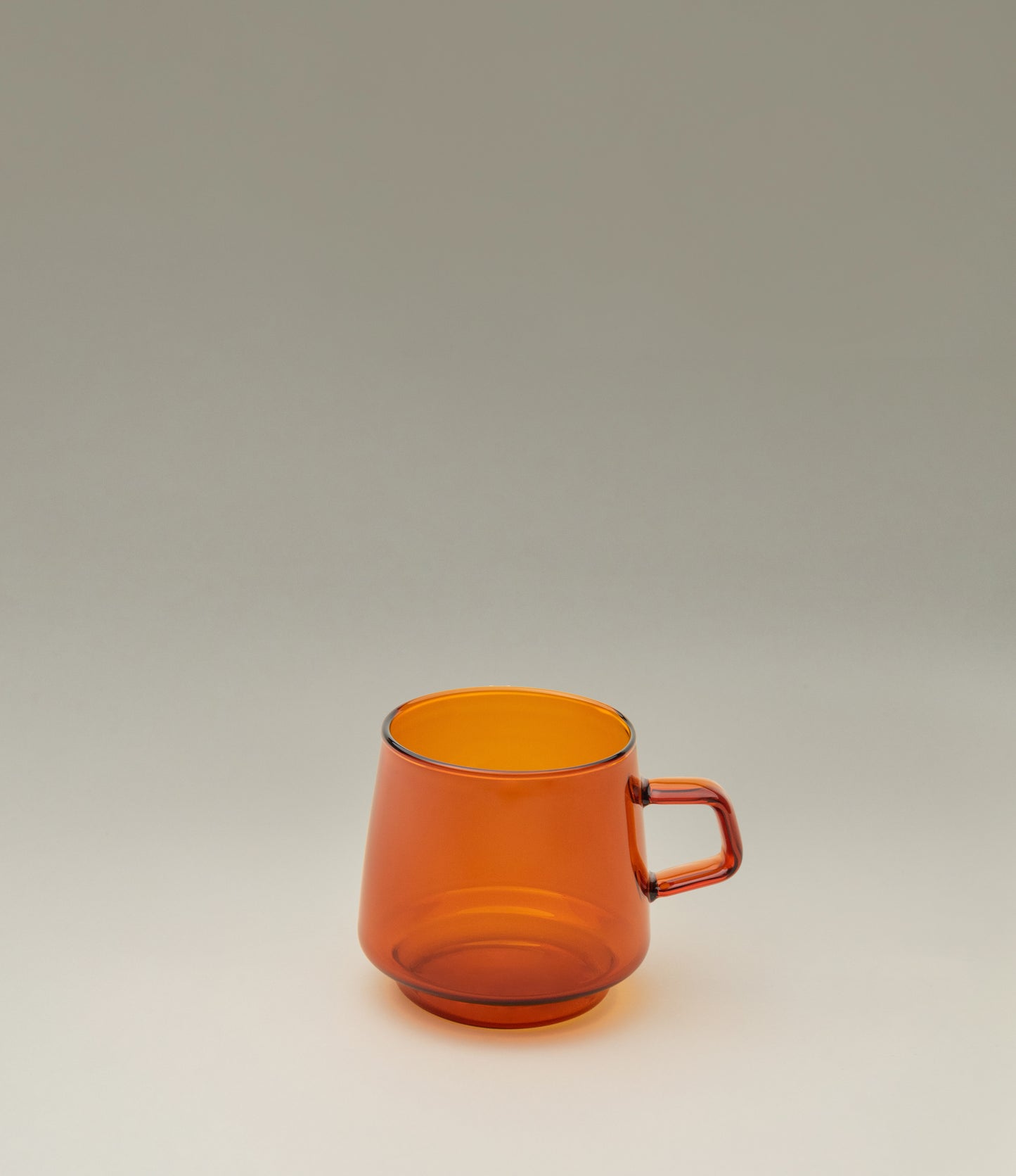 Sepia Mug is a glass mug from the japanese brand Kinto. The item is coming in the popular amber color which fits well the nostalgic shape of the product. The product has a small handle on the side.