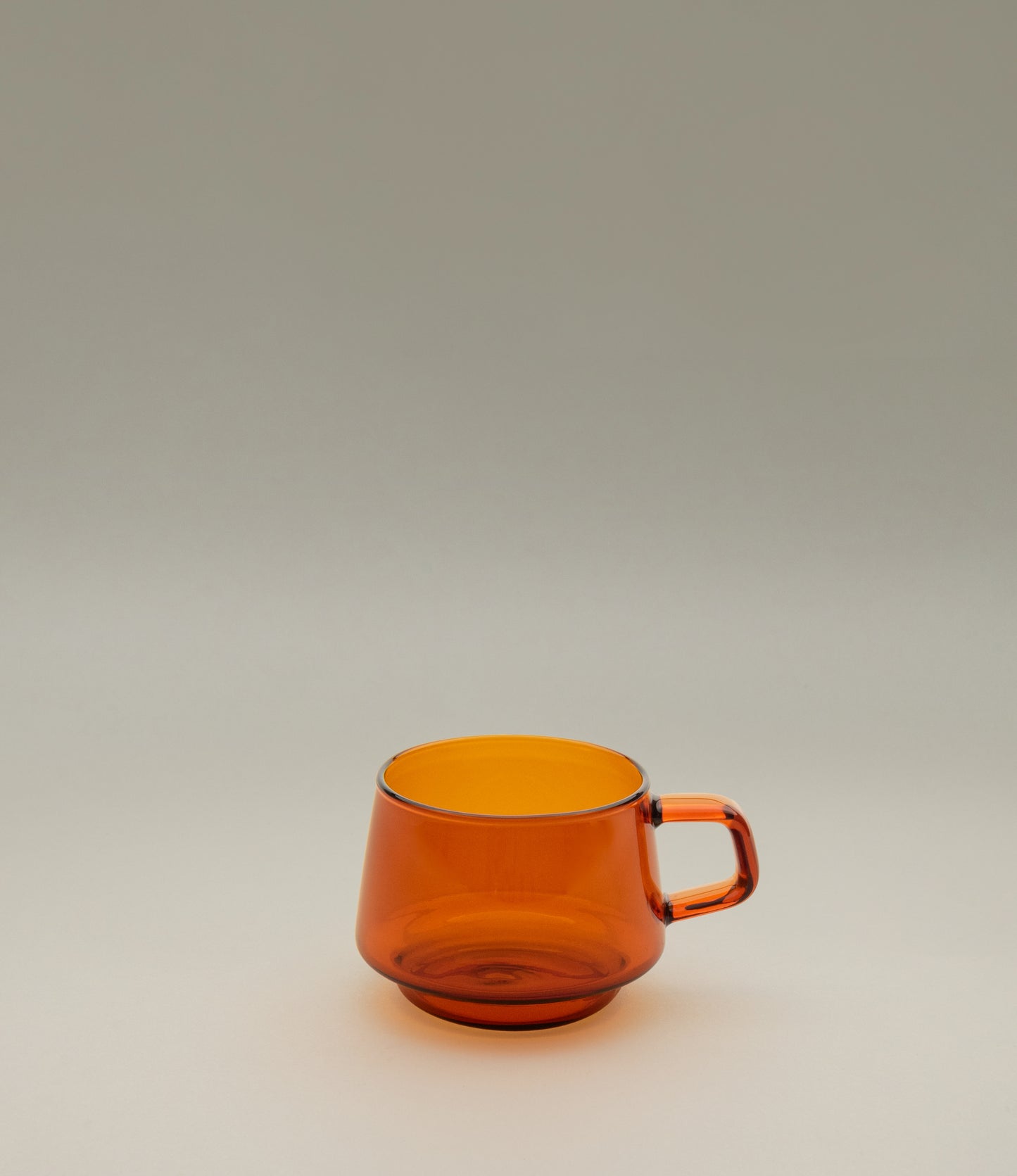 Sepia Cup is a glass mug from the japanese brand Kinto. The item is coming in the popular amber color which fits well the nostalgic shape of the product. The product can hold 270ml of liquid.