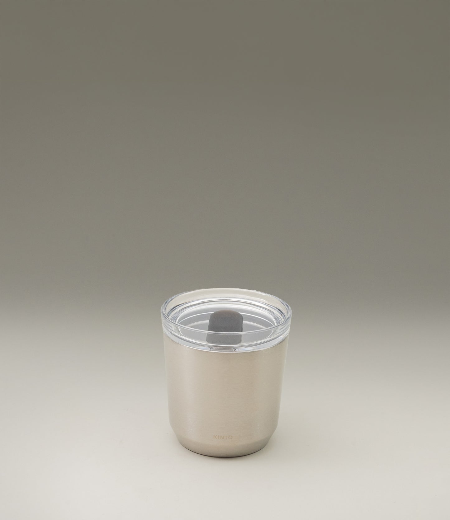 A takeaway cup from the japanese brand 'Kinto'. The To Go Tumbler is a matte stainless steel item, leak proof with a clear top part. The item retains the temperature and taste of your drink.