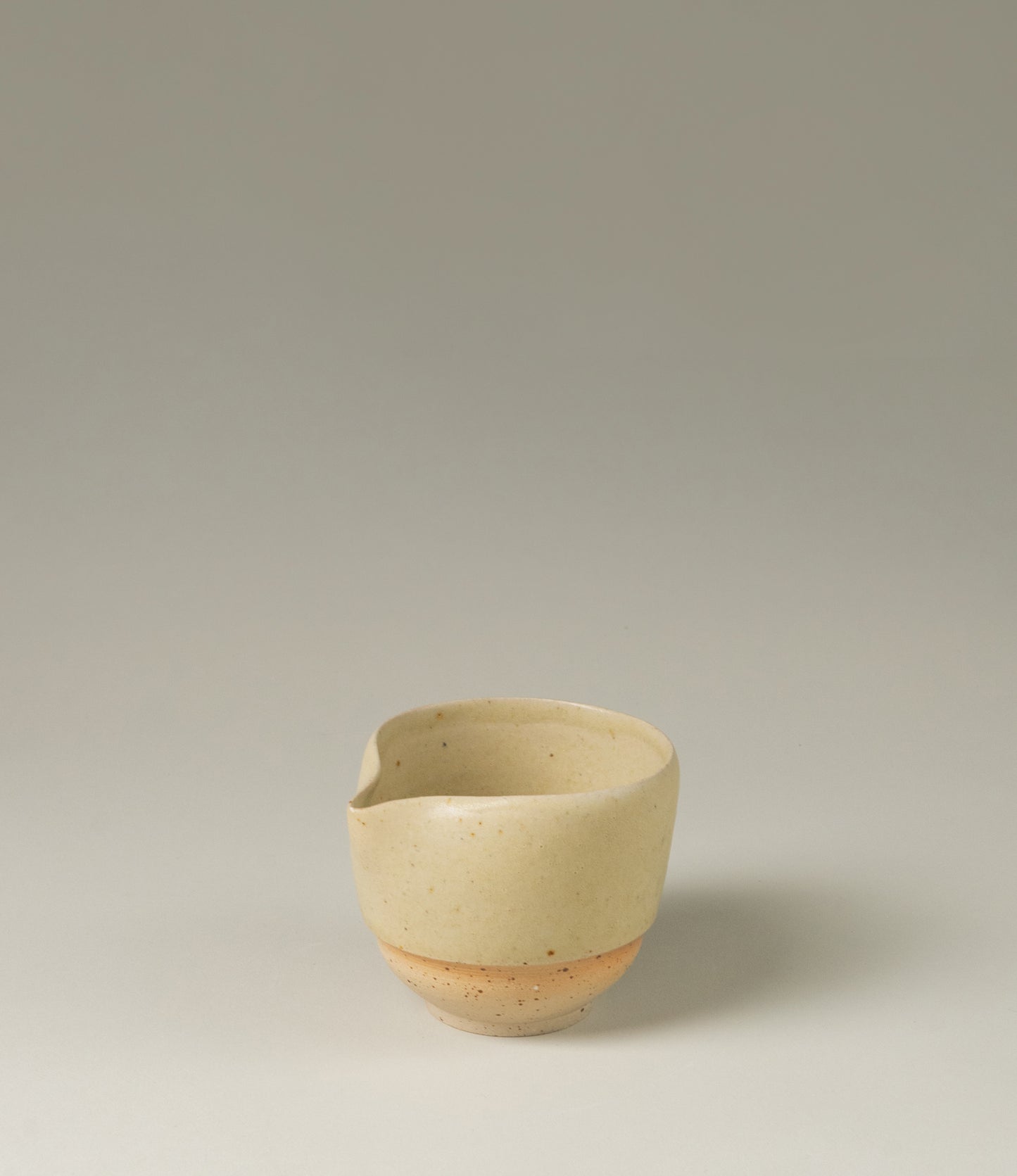 A pourer from Omni Ceramics, handmade in Belgium with an attention to detail. The product comes in a light beige natural color, with a painted orange gradient ring. The item is perfect to prepare your morning matcha tea.